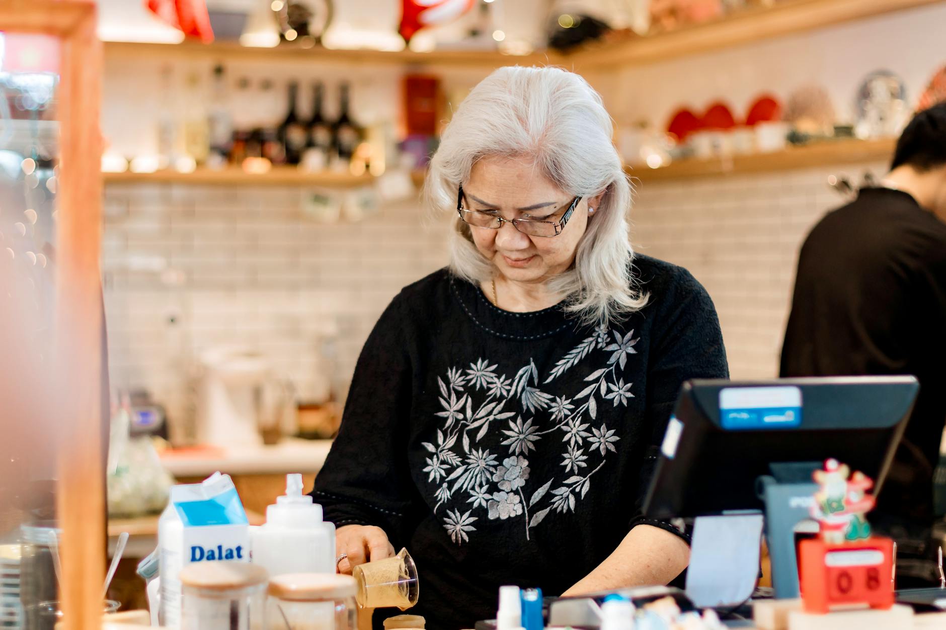 senior woman working in cozy coffee shop